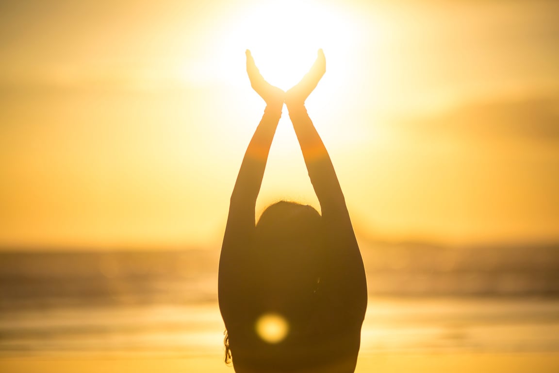 Woman doing meditation at sunset